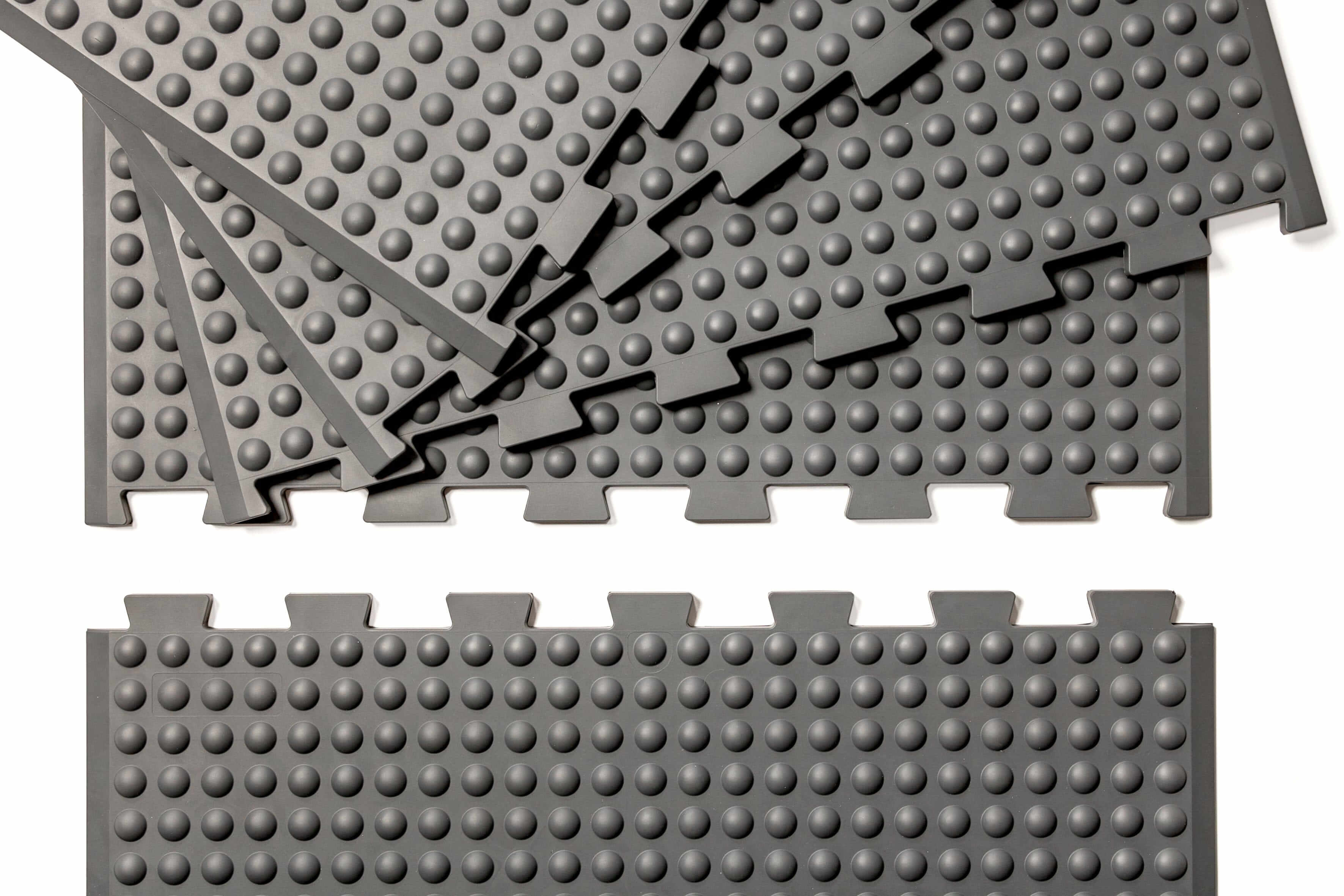 Grey GetUpMat Puzzle extension pieces for customizable standing mat, featuring interlocking design for easy width adjustment.