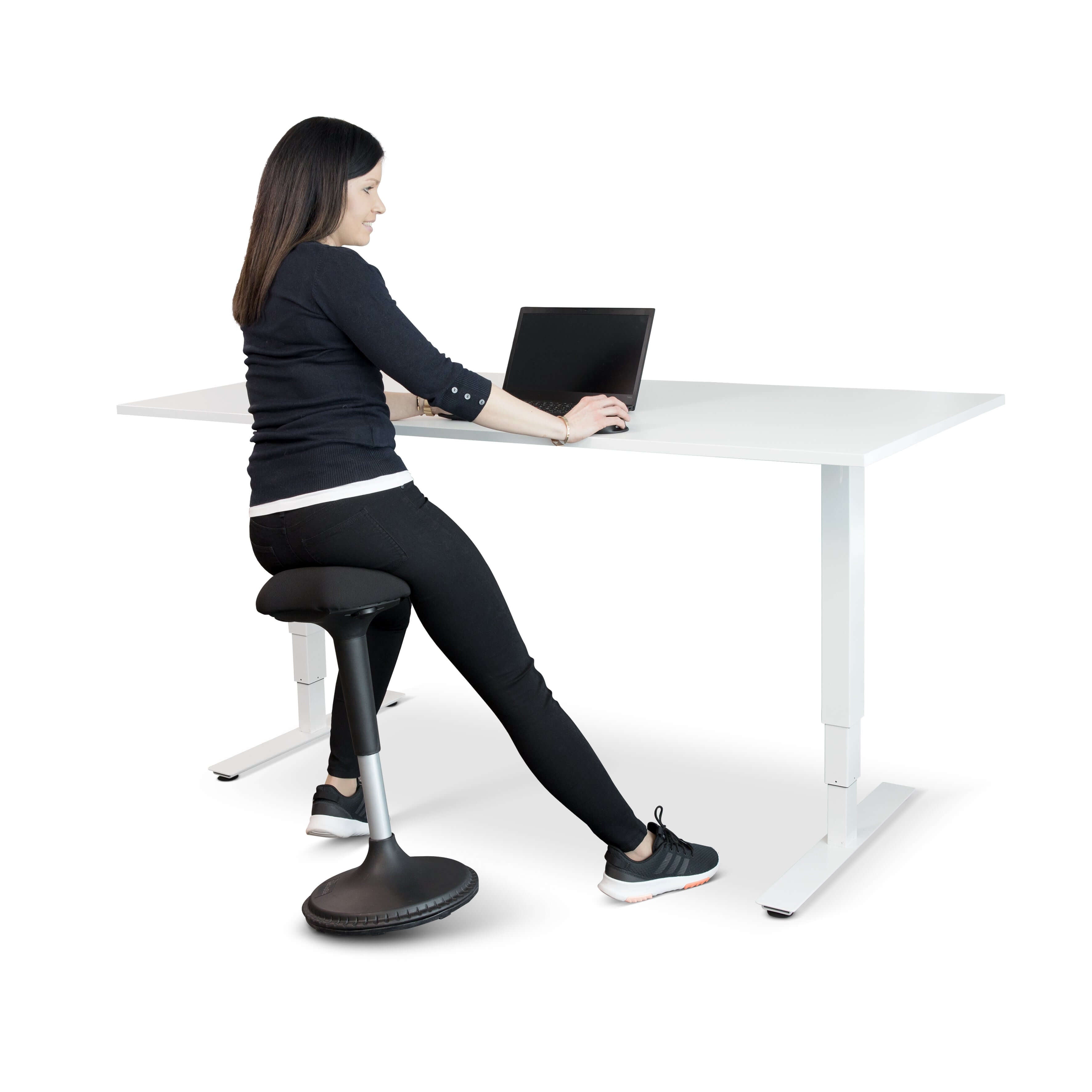 Woman using GetUpSit active chair at desk, featuring ergonomic design and rocking base for dynamic sitting in a workplace.