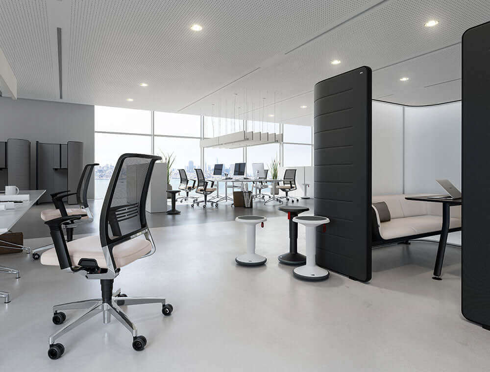 Modern office with UPis1 90 Junior stools in red, showcasing ergonomic design and 360-degree rotation for flexible work environments.