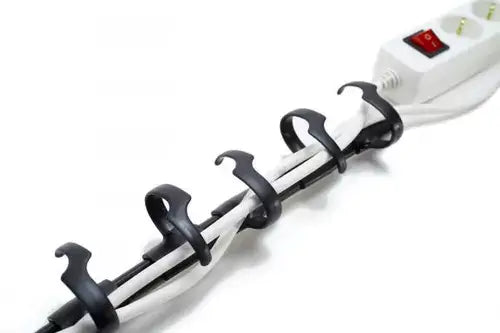 Cable organizer with black clips securing white cords and a power strip.