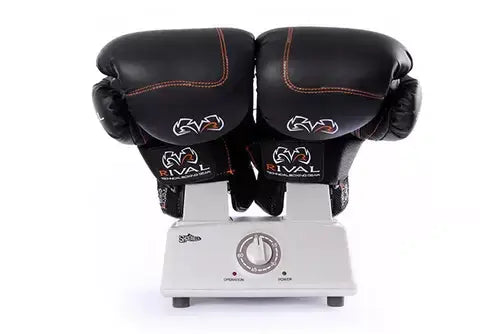 Shoe dryer and ozonator deodorizing boxing gloves on a white stand with a timer dial.