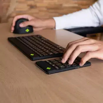 Person using the Ergo-R Black Numeric Keypad and wireless mouse on a wooden desk for efficient work setup.