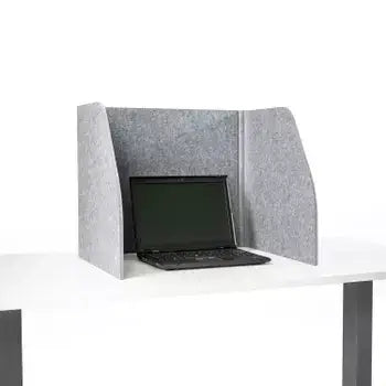 Grey foldable table screen guard with sound-absorbing fabric enclosing a laptop on a desk for a focused work environment.