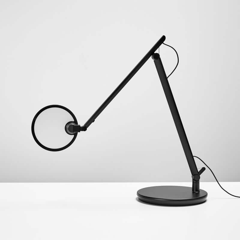 Black Nova desk lamp with desktop base, featuring adjustable LED light and sculptural design, ideal for modern workspaces.