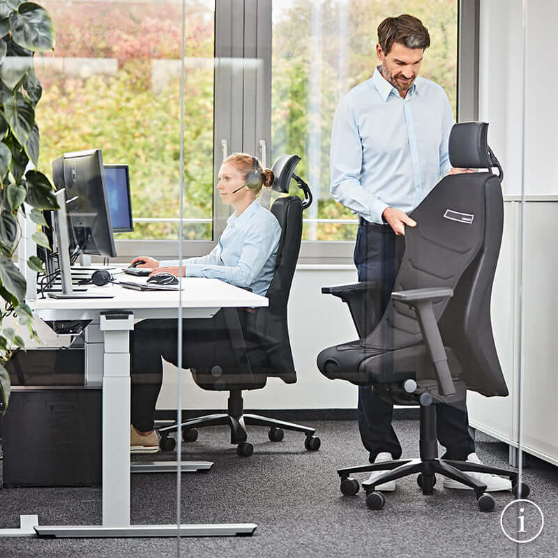 Two people using TWENTYFOURis5 ergonomic control room chairs in an office setting, highlighting adjustable features and comfort.