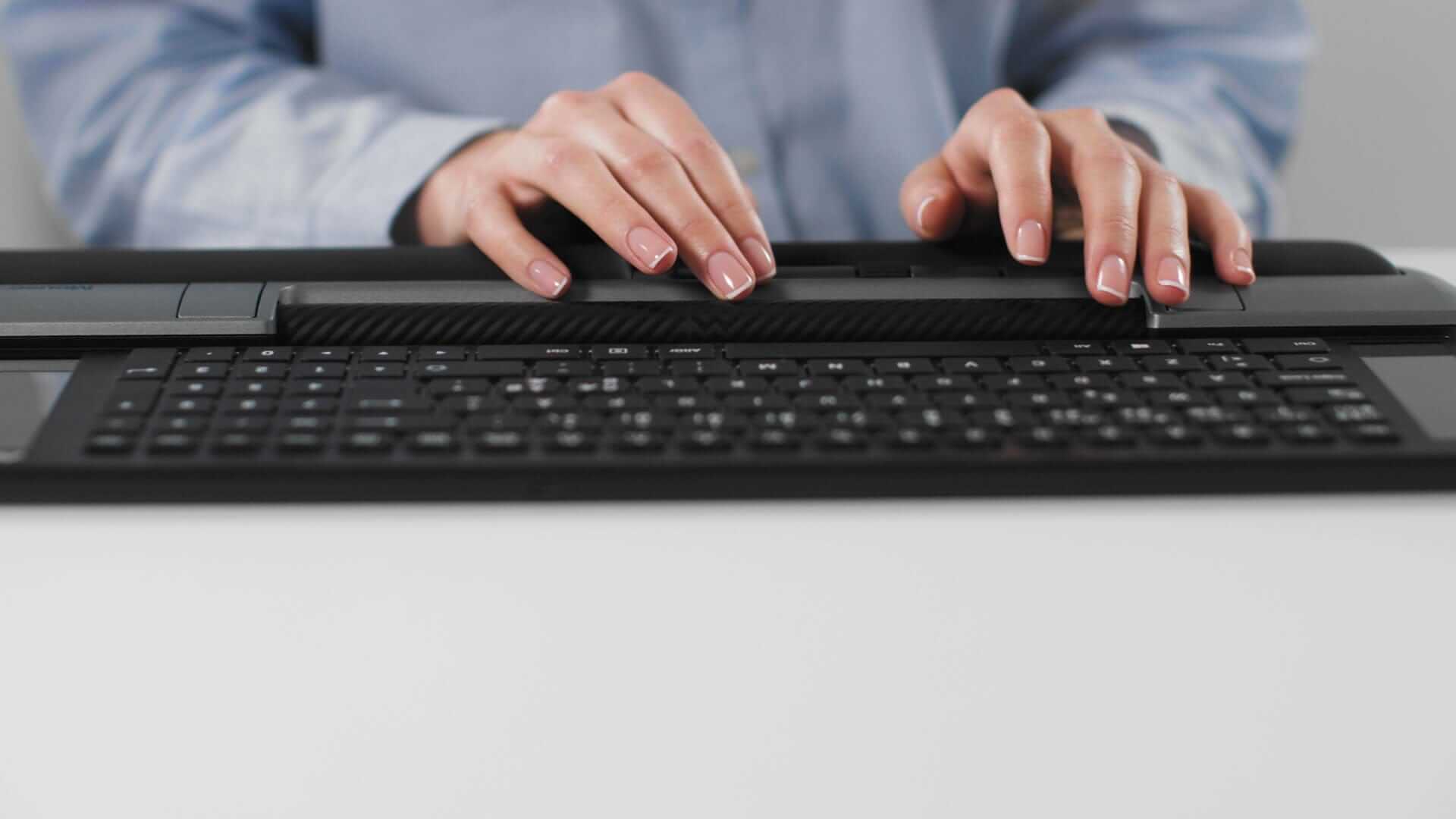 Person using Mousetrapper Delta Extended keyboard for seamless navigation and precise workflow.