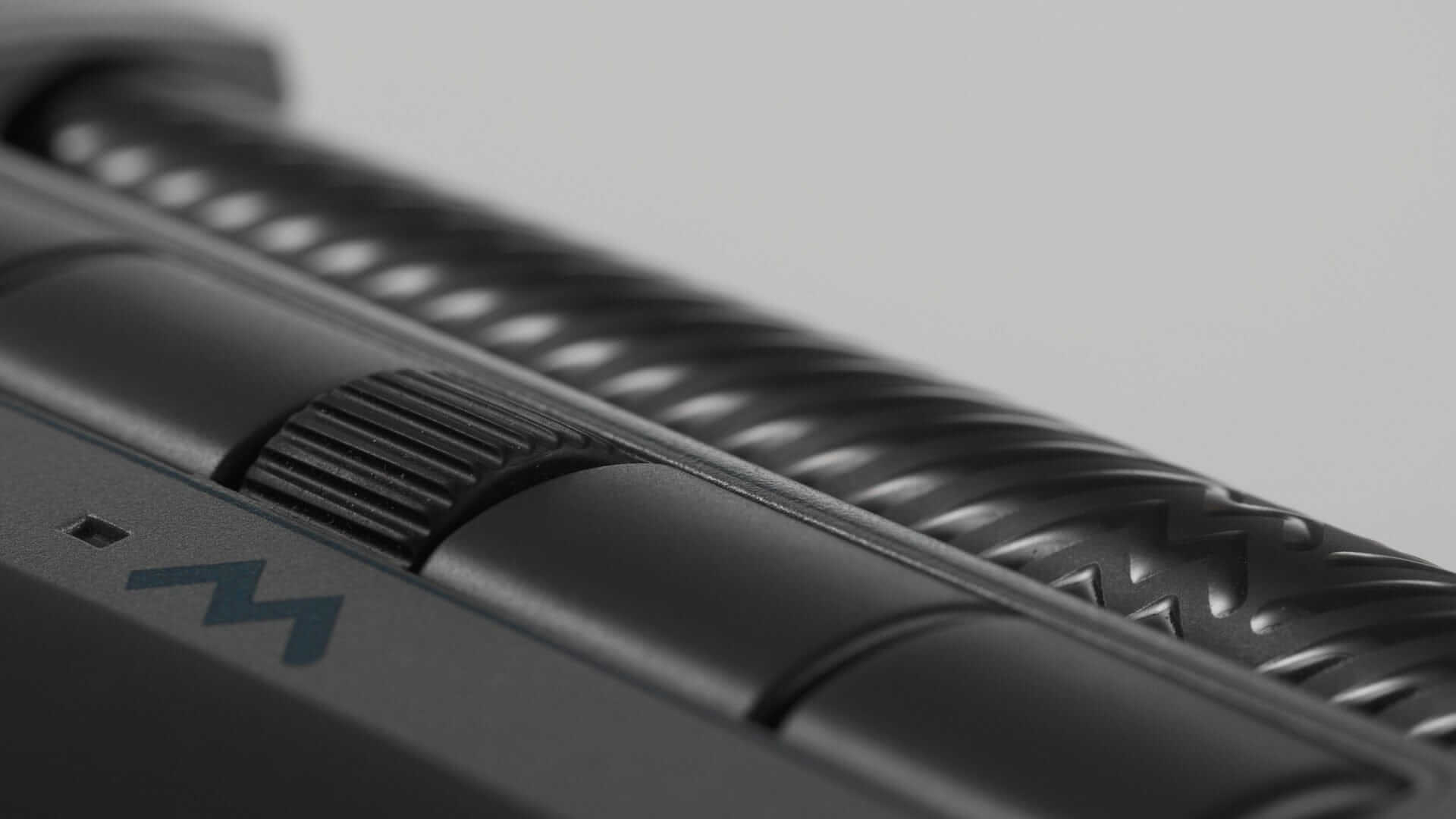 Close-up of Delta Extended mouse showing programmable buttons and ergonomic design in grey for precise navigation.