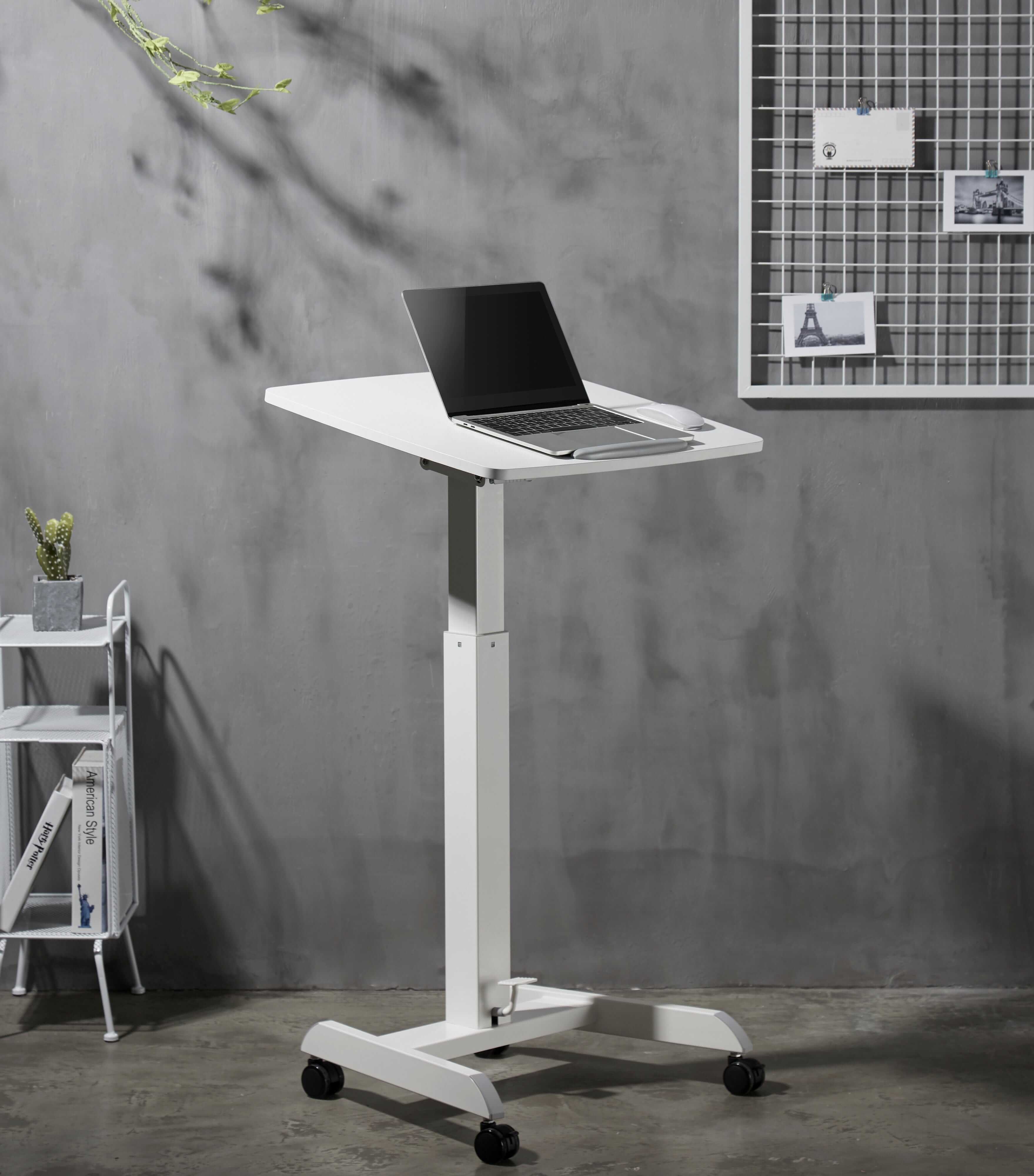 Adjustable white desk with a laptop, featuring tilt and height options, wheels, and a front stopper, ideal for versatile use.