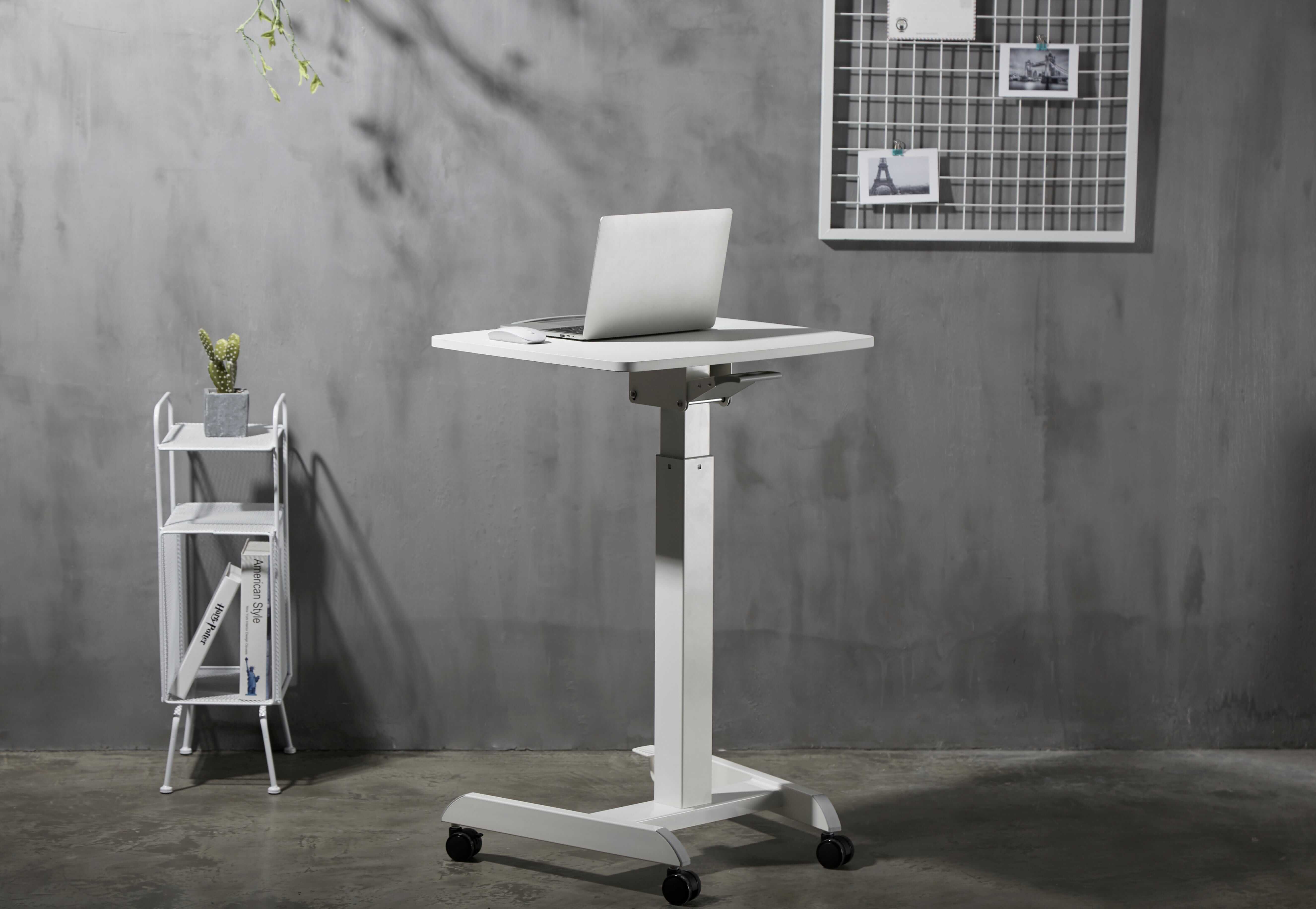 Adjustable GetUpDesk Tilt desk with laptop, featuring gas spring height adjustment and tilt options, shown in an office setting.